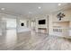 Bright living room with wood-look floors and a view into other living spaces at 8565 Silver Coast St, Las Vegas, NV 89139