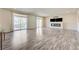 Open living area showcasing wood-look floors, fireplace, and sliding doors to a balcony at 8565 Silver Coast St, Las Vegas, NV 89139