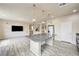 Open floor plan integrates kitchen, living area featuring a large island, stylish pendant lights and modern design at 8565 Silver Coast St, Las Vegas, NV 89139