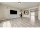 Spacious living room with modern flooring, neutral paint, a large television, and an open layout for comfortable living at 8565 Silver Coast St, Las Vegas, NV 89139