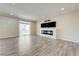 Open living space featuring wood-look floors, a fireplace, and balcony access at 8565 Silver Coast St, Las Vegas, NV 89139
