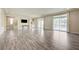 Bright living room with wood-look floors, sliding doors, and a built-in display niche at 8565 Silver Coast St, Las Vegas, NV 89139