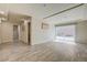 Spacious living room featuring wood floors, recessed lighting, and a sliding glass door to the backyard at 8565 Silver Coast St, Las Vegas, NV 89139