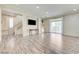 Inviting living room with wood-look floors, and sliding doors to a balcony at 8565 Silver Coast St, Las Vegas, NV 89139