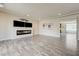 Open living room with wood-look floors and a modern fireplace feature wall at 8565 Silver Coast St, Las Vegas, NV 89139