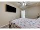 Well-lit bedroom features a ceiling fan, wood floors, and a view into the hallway at 8565 Silver Coast St, Las Vegas, NV 89139