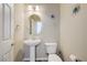 Stylish powder room with pedestal sink, decorative mirror, and flower-themed wall decor at 8565 Silver Coast St, Las Vegas, NV 89139