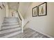 Bright entryway featuring wood-look floors and a staircase with white risers at 8565 Silver Coast St, Las Vegas, NV 89139