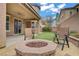 Backyard boasts a cozy fire pit area and patio, perfect for relaxation and entertainment at 9557 Belmont Bay Ave, Las Vegas, NV 89148