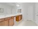 Bright bathroom featuring dual vanities, a large mirror, a vanity area, and a separate water closet at 9557 Belmont Bay Ave, Las Vegas, NV 89148