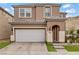 Two-story home features a front yard, two-car garage, and desert landscaping at 9557 Belmont Bay Ave, Las Vegas, NV 89148