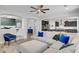 Open-concept living room with contemporary furnishings, connecting seamlessly to the kitchen at 9557 Belmont Bay Ave, Las Vegas, NV 89148
