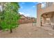 Expansive backyard with low-maintenance gravel landscaping, covered patio, and a glimpse of the inviting pool area at 9614 Stonily Ln, Las Vegas, NV 89178