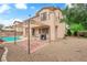 Spacious backyard featuring a covered patio area, gravel landscaping, and a refreshing pool with rock features at 9614 Stonily Ln, Las Vegas, NV 89178
