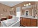 Luxurious bathroom featuring a soaking tub and and sinks at 9614 Stonily Ln, Las Vegas, NV 89178