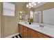 Bathroom vanity with double sinks, lighting, and neutral toned walls and cabinets at 9614 Stonily Ln, Las Vegas, NV 89178