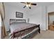 Welcoming bedroom with comfortable bedding, hardwood floors and a ceiling fan at 9614 Stonily Ln, Las Vegas, NV 89178