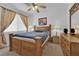 Comfortable bedroom with wooden furniture, patterned curtains, and a ceiling fan at 9614 Stonily Ln, Las Vegas, NV 89178