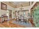 Formal dining room with hardwood floors, chandelier, and adjacent butler's pantry at 9614 Stonily Ln, Las Vegas, NV 89178
