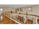Hallway with hardwood floors overlooking the living area below, and neutral paint at 9614 Stonily Ln, Las Vegas, NV 89178