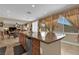 Kitchen featuring a large granite island, stainless dishwasher, with a glimpse into the adjacent living area at 9614 Stonily Ln, Las Vegas, NV 89178