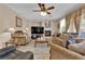 Inviting living room with fireplace, neutral tones, and comfortable seating arrangement at 9614 Stonily Ln, Las Vegas, NV 89178