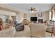 Open living space with fireplace, comfortable armchairs, and view into a dining area at 9614 Stonily Ln, Las Vegas, NV 89178