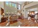 Bright living room with hardwood floors, large windows, and an open floor plan at 9614 Stonily Ln, Las Vegas, NV 89178