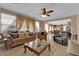 Open living space with large sofa, chair, and view of dining area and kitchen at 9614 Stonily Ln, Las Vegas, NV 89178