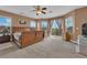Spacious main bedroom featuring carpet, large windows, and a ceiling fan at 9614 Stonily Ln, Las Vegas, NV 89178