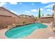 Backyard pool with beautiful rock features, perfect for cooling off and enjoying the outdoors in a private setting at 9614 Stonily Ln, Las Vegas, NV 89178