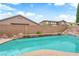 Beautiful pool area with rock features and privacy wall, creating a serene and private backyard oasis at 9614 Stonily Ln, Las Vegas, NV 89178