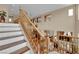 Staircase with wood railings and trim offers a view of the downstairs living area at 9614 Stonily Ln, Las Vegas, NV 89178