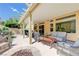 Expansive backyard with a covered patio, fire pit, and comfortable seating, ideal for entertaining at 9729 Hawk Crest St, Las Vegas, NV 89141