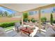 Relaxing covered patio with a charming fire pit and comfortable seating, surrounded by lush landscaping at 9729 Hawk Crest St, Las Vegas, NV 89141
