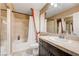Stylish bathroom featuring a tub, shower, a vanity with a dark wood finish, and a large mirror at 9729 Hawk Crest St, Las Vegas, NV 89141
