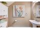 Charming half bathroom with a pedestal sink and artwork at 9729 Hawk Crest St, Las Vegas, NV 89141