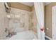 A well-lit bathroom with a tiled bathtub, shower curtain, and chrome fixtures at 9729 Hawk Crest St, Las Vegas, NV 89141