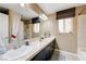 Bathroom with double sinks, granite countertop, and window at 9729 Hawk Crest St, Las Vegas, NV 89141