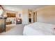 Bright bedroom featuring sitting area, neutral walls, white comforter, and an ensuite bathroom at 9729 Hawk Crest St, Las Vegas, NV 89141