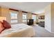 Spacious bedroom with two windows, sitting area, dresser, neutral walls, and carpet at 9729 Hawk Crest St, Las Vegas, NV 89141