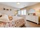 Bedroom with floral bedding, natural light, and a mirrored closet at 9729 Hawk Crest St, Las Vegas, NV 89141
