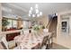 Bright dining room with a chandelier, staircase, and open layout to the living area at 9729 Hawk Crest St, Las Vegas, NV 89141