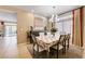 Elegant dining room featuring a floral tablecloth, large window, and stylish decor at 9729 Hawk Crest St, Las Vegas, NV 89141