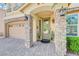 Charming front porch with stone columns and brick-paved driveway leading to the garage at 9729 Hawk Crest St, Las Vegas, NV 89141