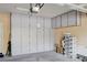 Clean garage featuring built-in storage cabinets and shelving units for efficient organization at 9729 Hawk Crest St, Las Vegas, NV 89141