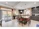 Open kitchen featuring an island with barstool seating and glass sliding doors to backyard at 9729 Hawk Crest St, Las Vegas, NV 89141