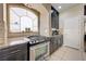 Modern kitchen features stainless steel oven, custom cabinets, and beautiful arched window at 9729 Hawk Crest St, Las Vegas, NV 89141