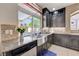 Granite counters surround the stainless steel sink, faucet, and dishwasher in this bright kitchen at 9729 Hawk Crest St, Las Vegas, NV 89141
