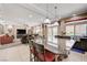 Open-concept kitchen with granite countertop island, dining space, and access to backyard at 9729 Hawk Crest St, Las Vegas, NV 89141